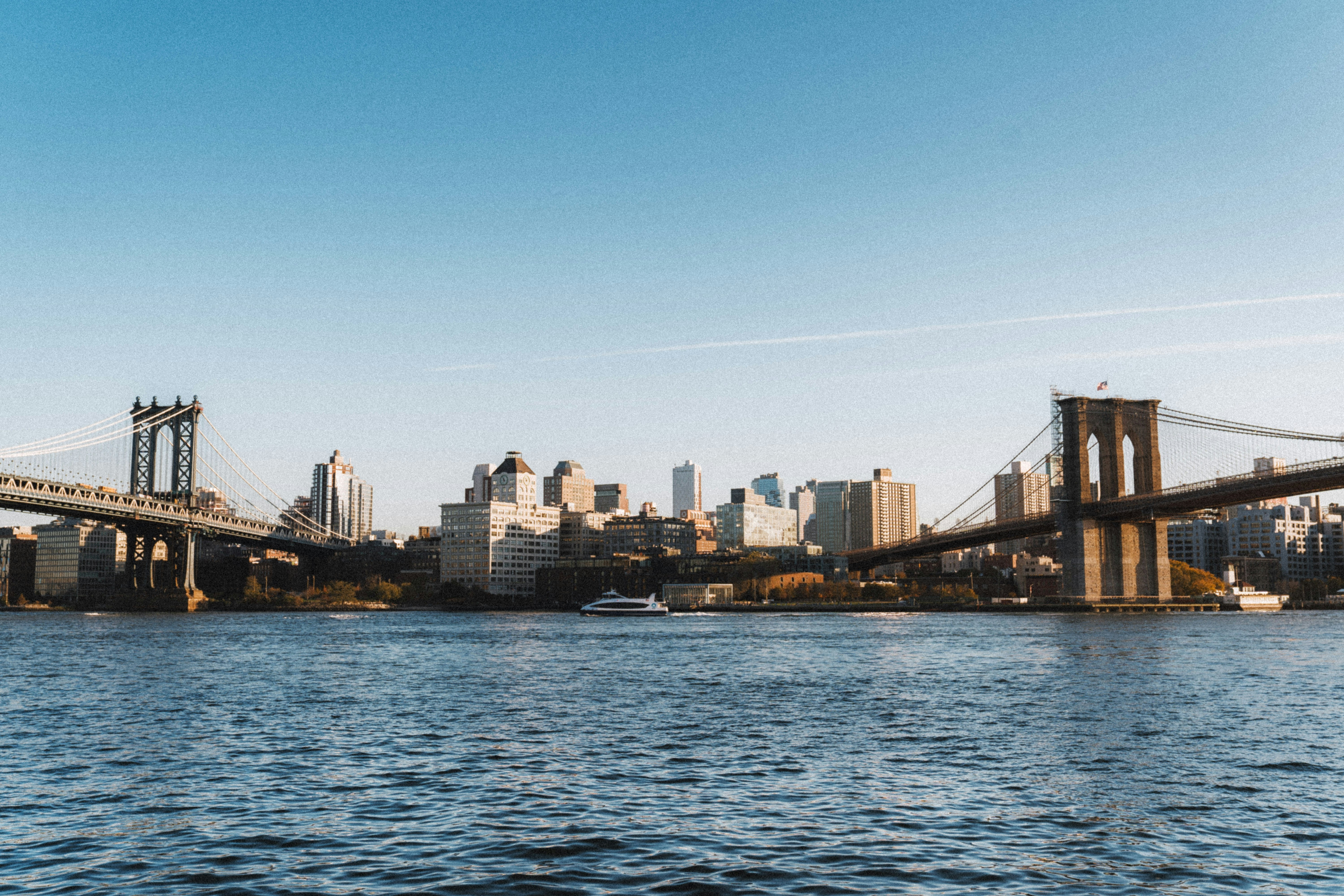 brown bridge over body of water during daytime